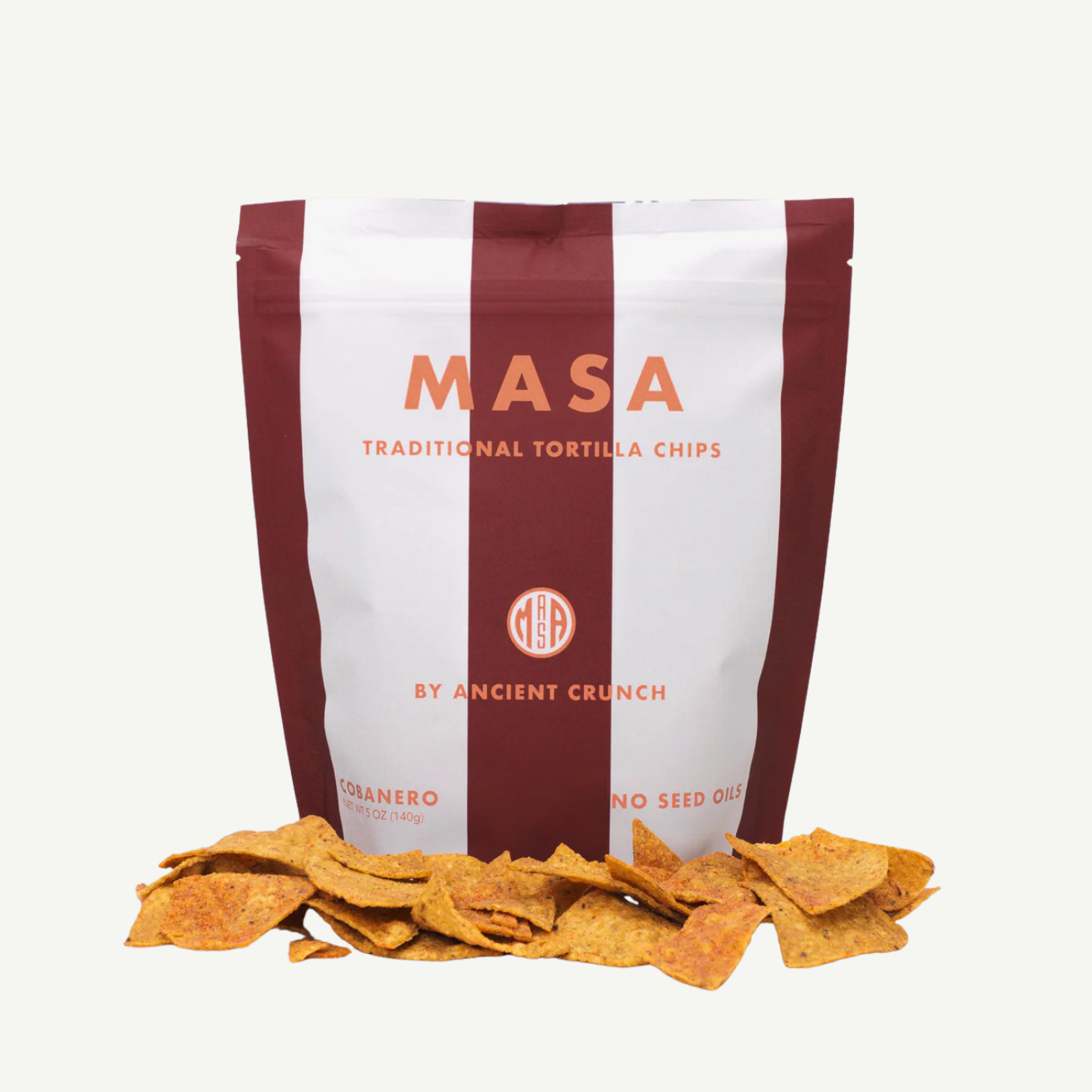 Bag of MASA traditional tortilla chips with chips spilling out on a white background